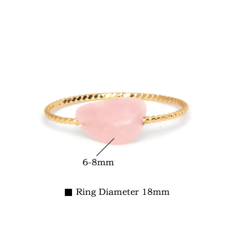 Women's geometric ring with a niche cut in a coloured agate stone on a plain background.
