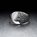 Geometric silver wolf head men's ring made of alloy metal on a grey background.