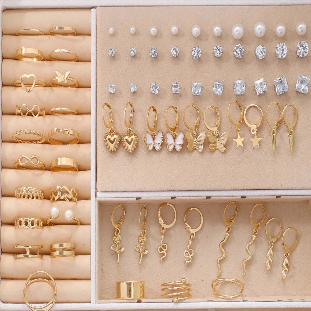 108 gold and yellow geometric and round alloy drop earrings laid out.