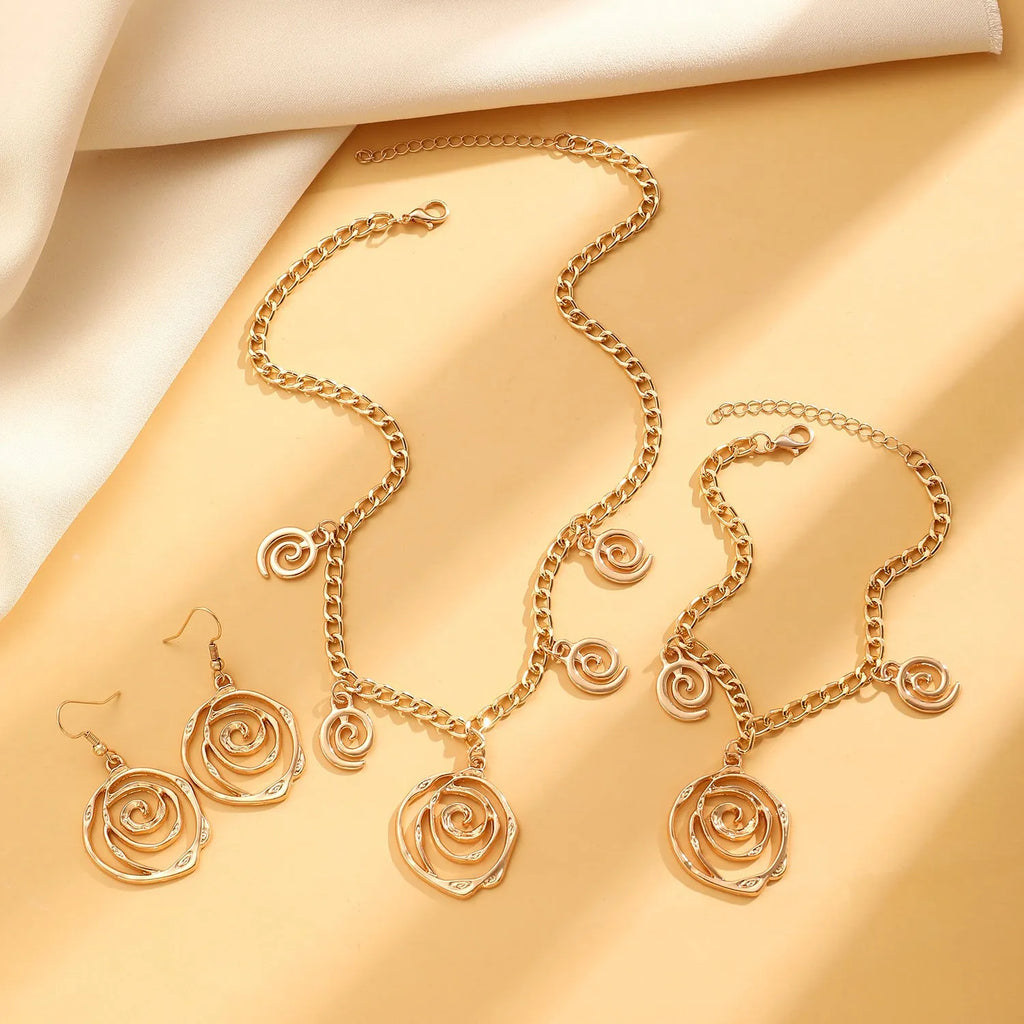 Women's spiral donut jewellery set with necklace, bracelet and earrings in gold or silver geometric design