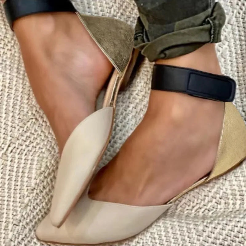 Women's beige velcro sandals with a hollowed flat design on a neutral background.