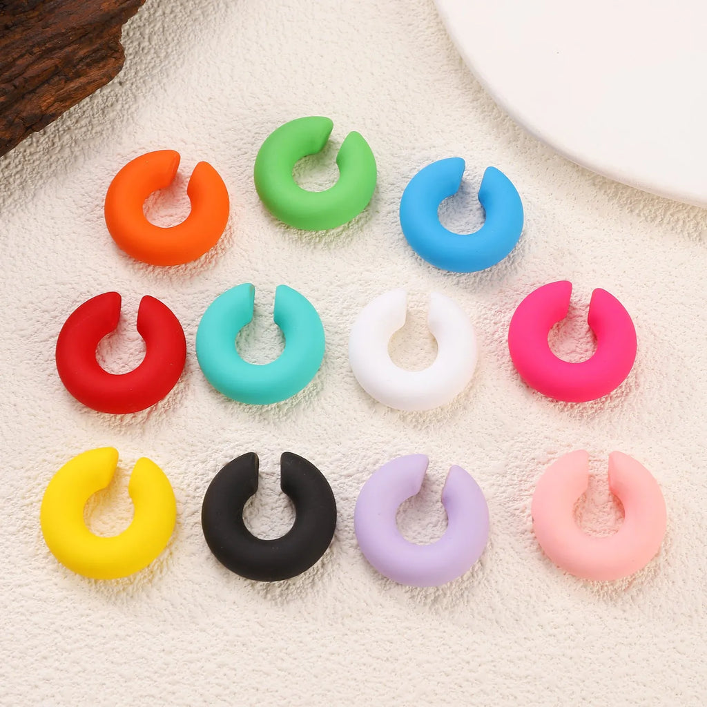 Round C-shaped geometric clip-on earrings with matte finish in various candy colours