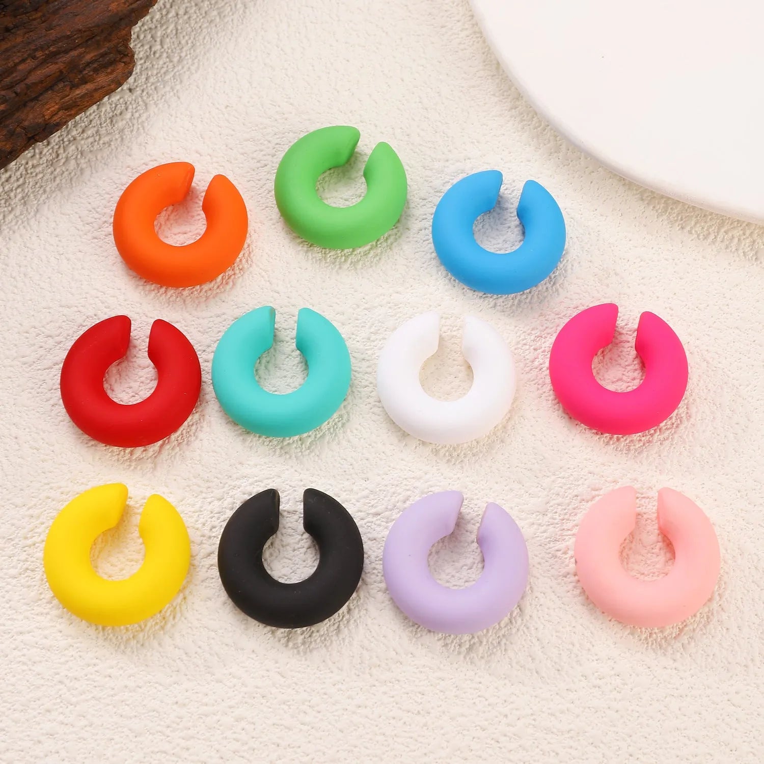 Round C-shaped geometric clip-on earrings with matte finish in various candy colours