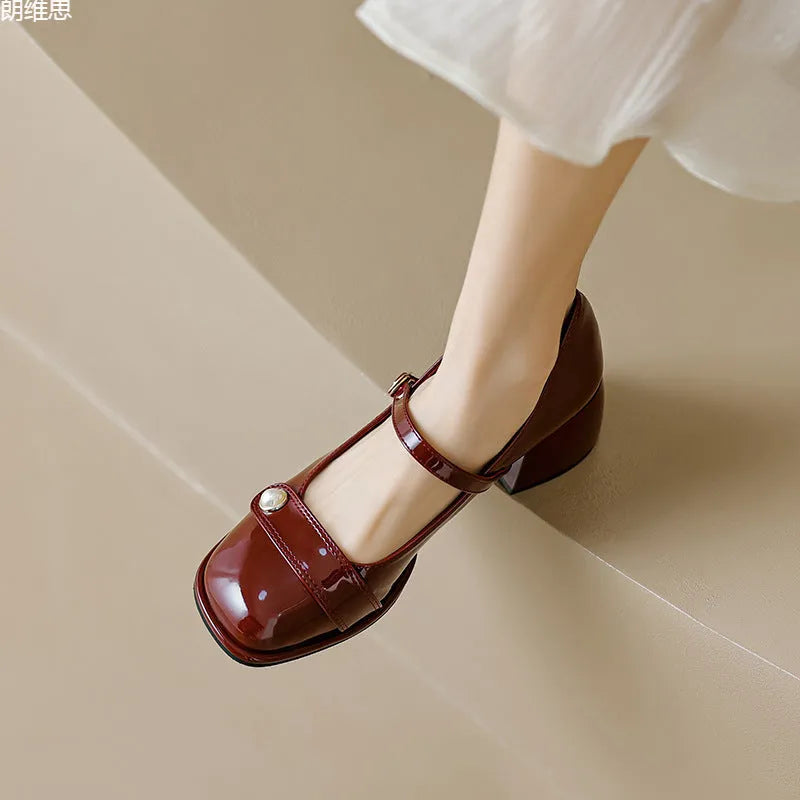 Womens mid-top patent leather ankle boots with a square toe and chunky block heel in apricot colour.