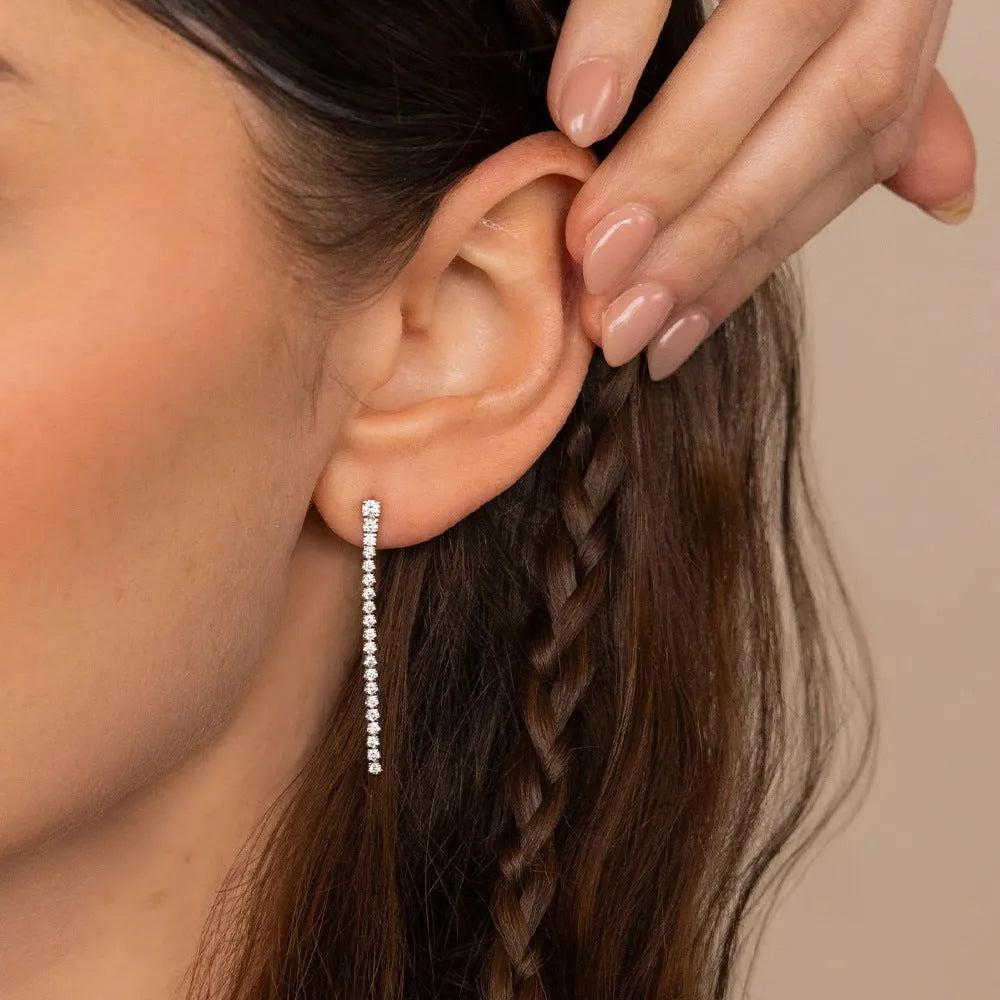 Geometric line pattern stainless steel stud earrings with zircon stones in gold colour.