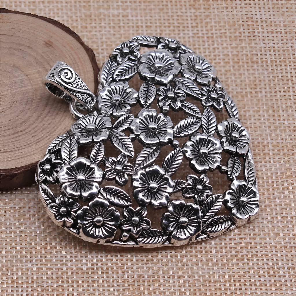 Ancient silver hollow flower love pendant measuring 67mm by 58mm with electroplated finish