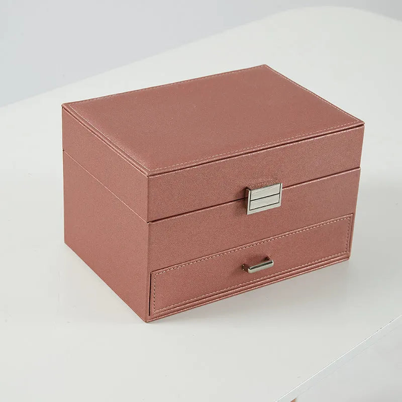 Hard black PU leather jewellery storage box with organised compartments for rings and necklaces.