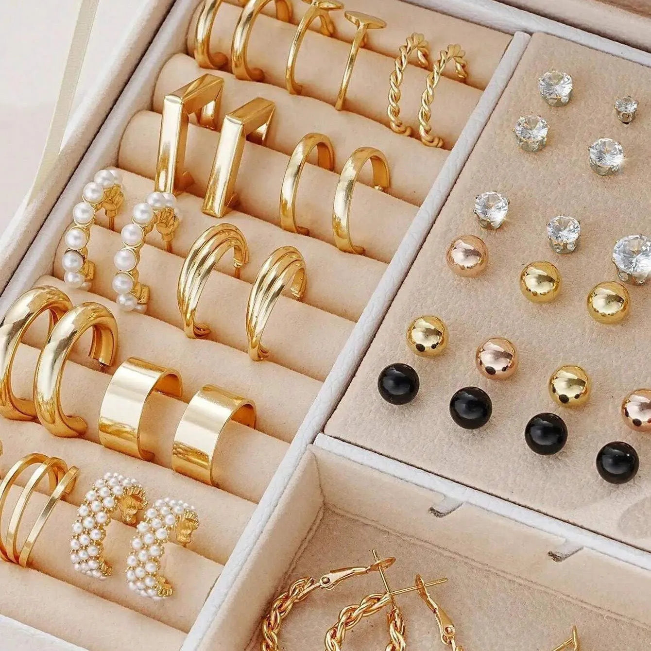 108 gold and yellow geometric and round alloy drop earrings laid out.
