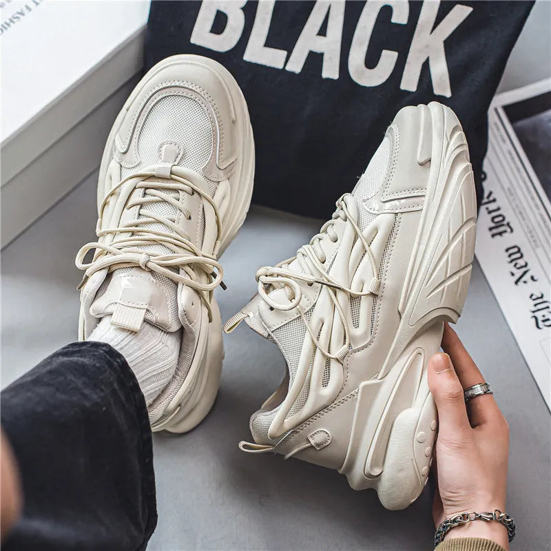 Men's beige and black sneakers with mesh upper, lace-up front, and rubber sole