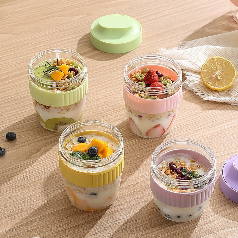 Green plastic salad cup with clear lid and white spoon on a table