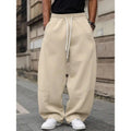 Man wearing dark grey high-waisted straight-leg cropped casual trousers made from bamboo fibre.