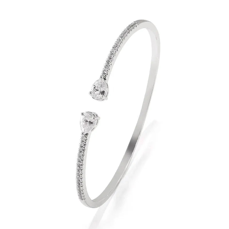 Copper bracelet with inlaid zircon stones in white or blue colour options