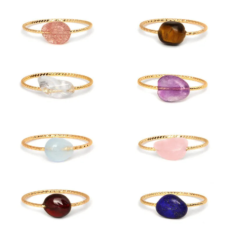 Women's geometric ring with a niche cut in a coloured agate stone on a plain background.