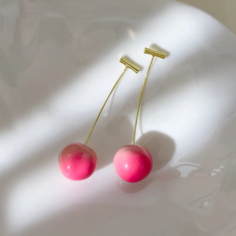 Handmade acrylic peach fruit earrings showing small and large size options with copper findings