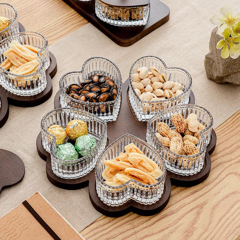 Glass serving platter with heart-shaped transparent lids in a 4-grid configuration on a table.