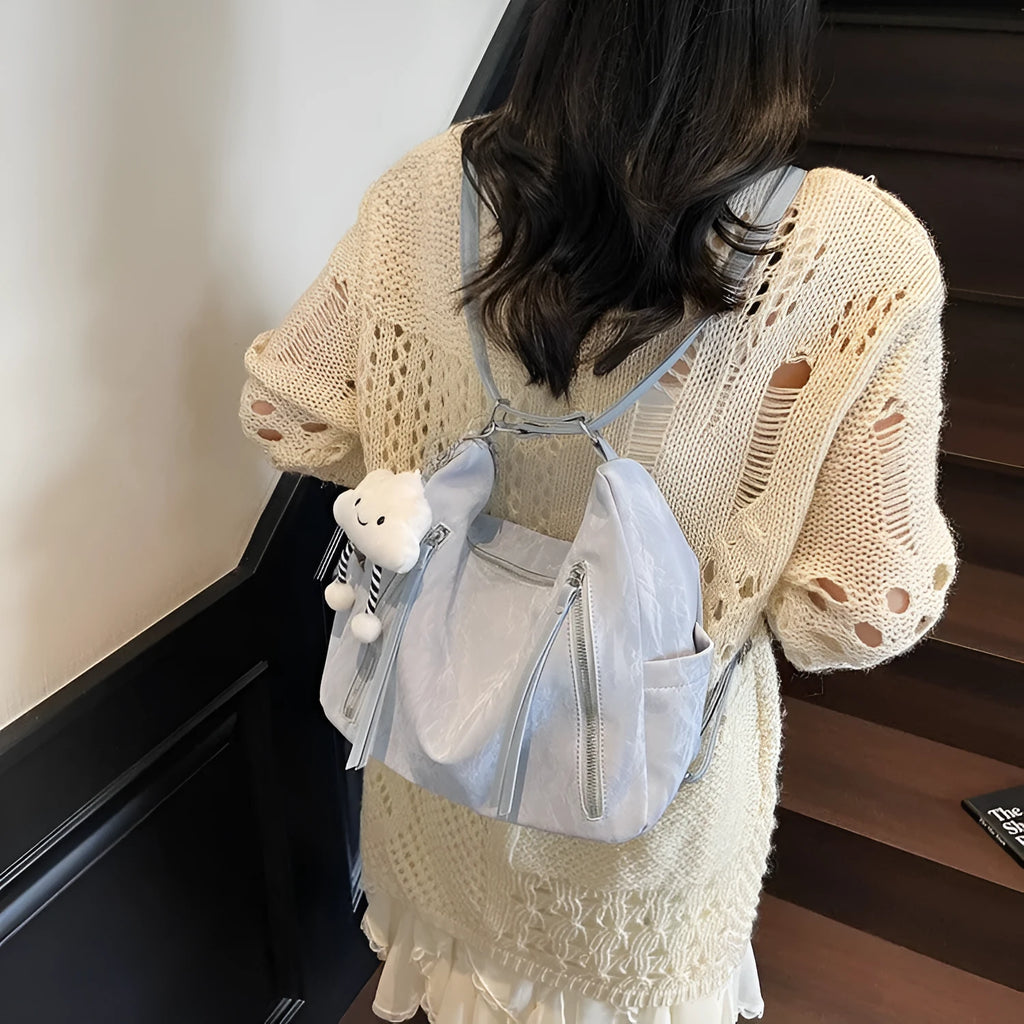 Women's soft PU backpack in neutral colours with pendant accessory