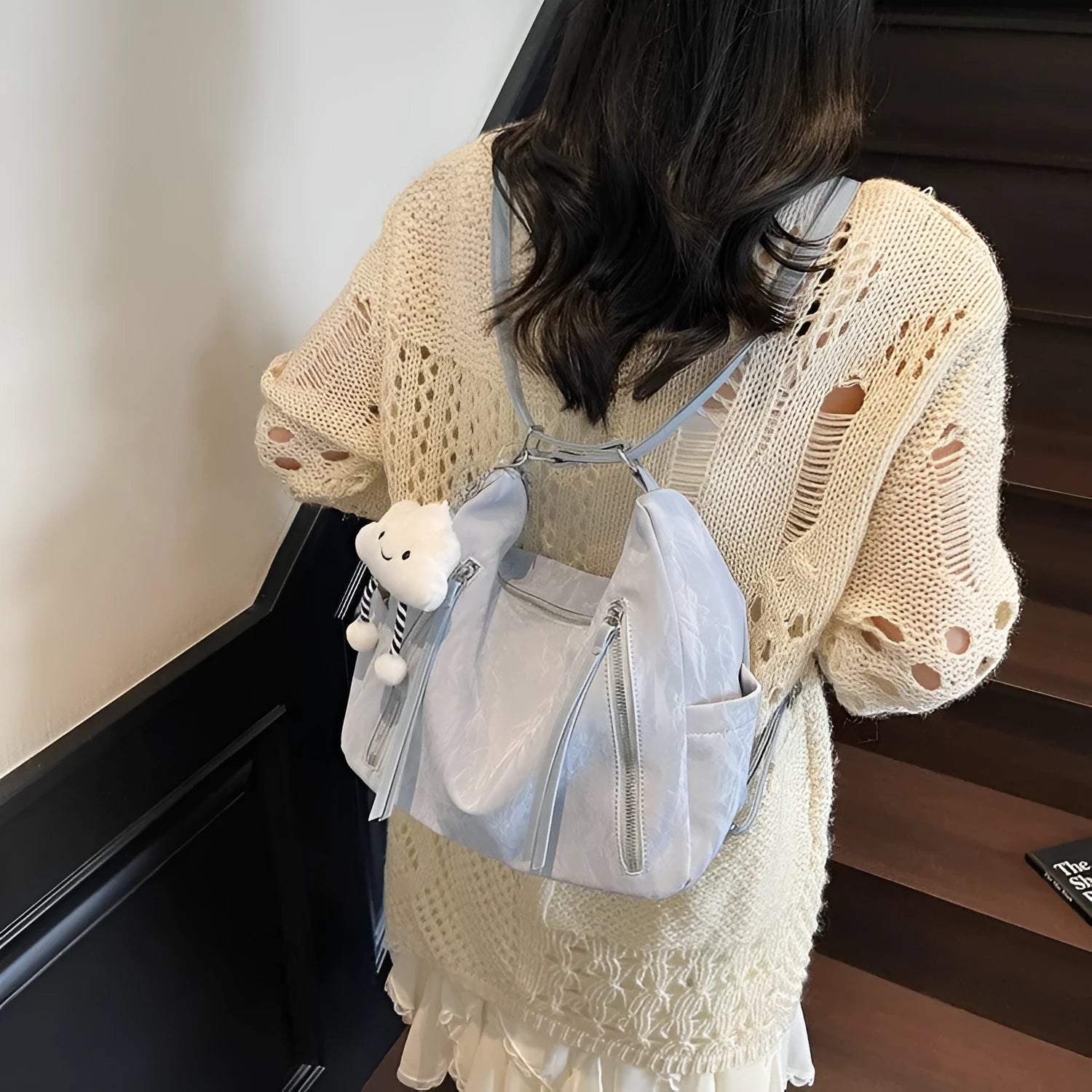 Women's soft PU backpack in neutral colours with pendant accessory