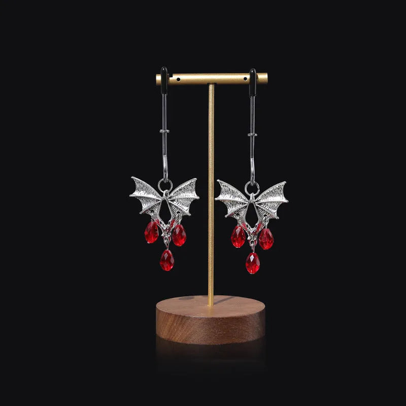 Silver diamond bat design nipple clamp with ruby accents and adjustable tension mechanism
