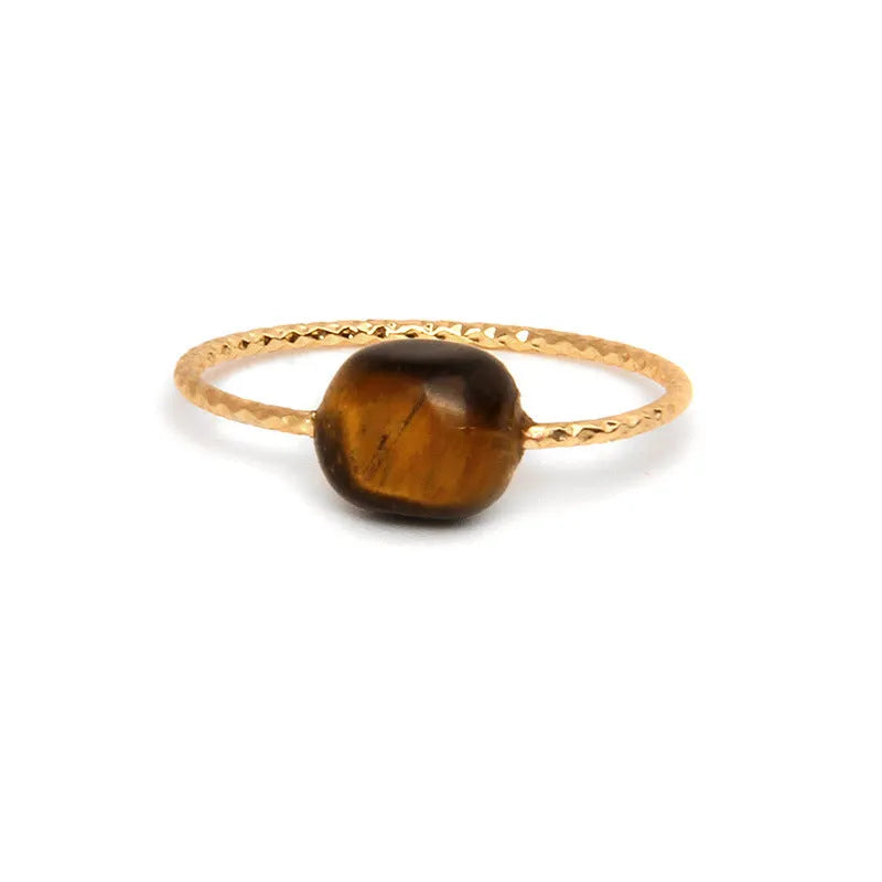 Geometric silver-toned ring setting with a central oval of blue and white banded agate stone on a woman's hand.
