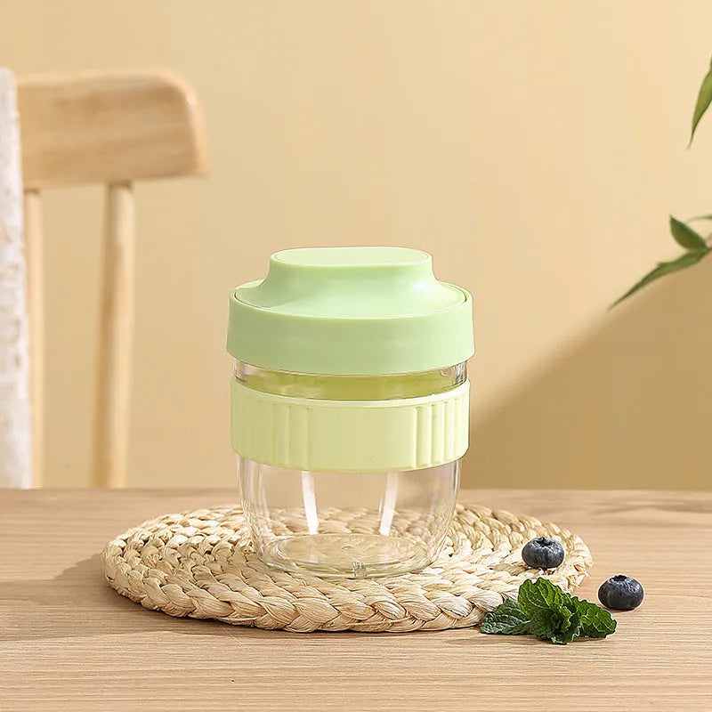 Green plastic salad cup with clear lid and white spoon on a table