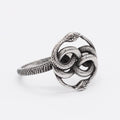 A titanium steel double snake ring in a steel colour on a neutral background.