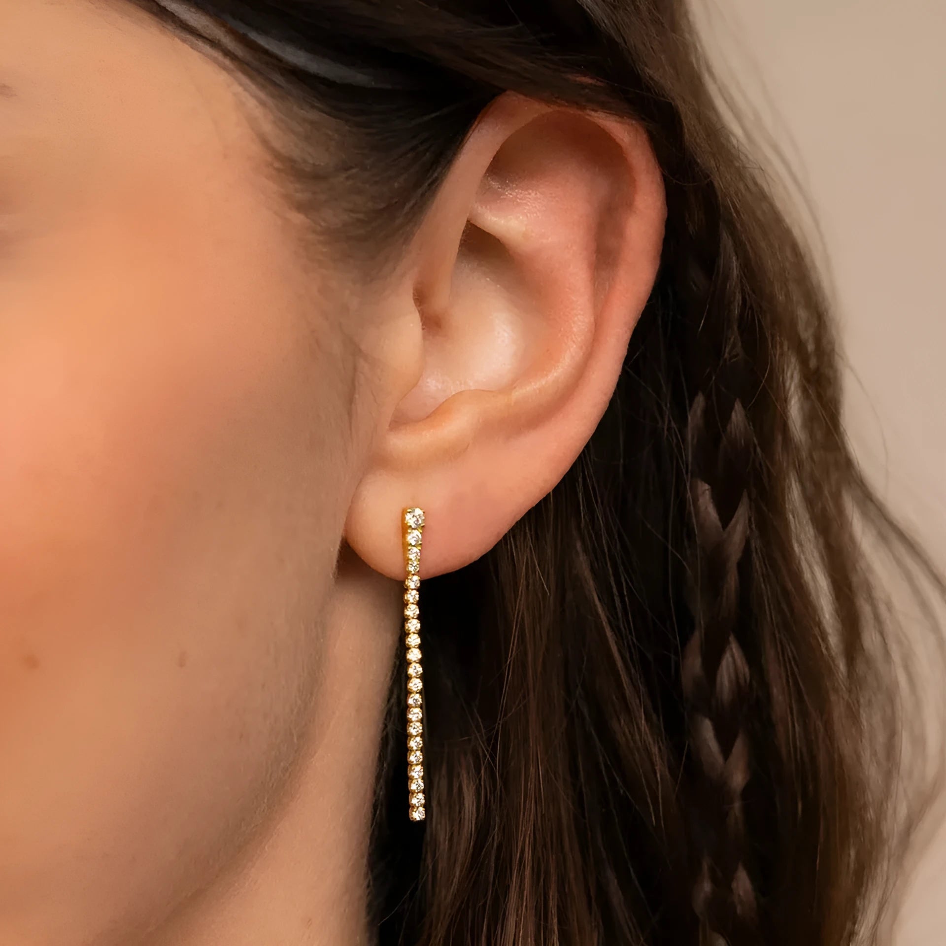 Geometric line pattern stainless steel stud earrings with zircon stones in gold colour.