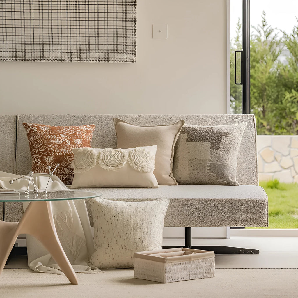A square coreless decorative sofa cushion with an abstract geometric pattern in red and brown colours.