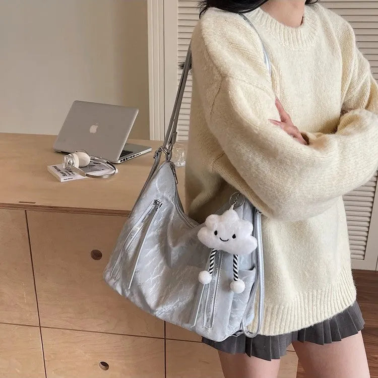 Women's soft PU backpack in neutral colours with pendant accessory