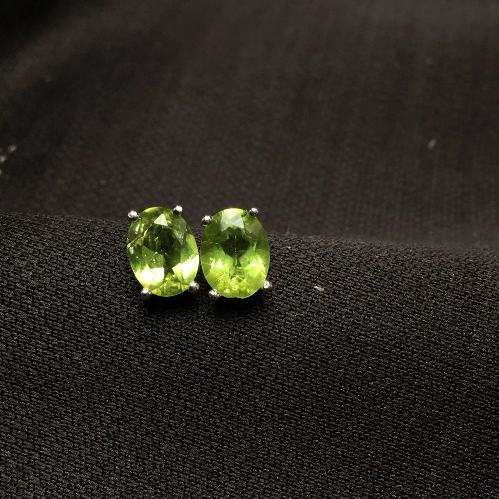 Natural grass green olivine faceted stud earrings in S925 silver, oval stone 6mm by 8mm.