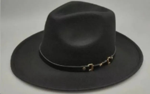 Brown leather velvet curved edge Western cowboy hat with a conical crown on a wooden surface.
