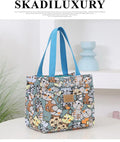 Women's square canvas handbag with floral and animal prints, showing aluminium hardware.