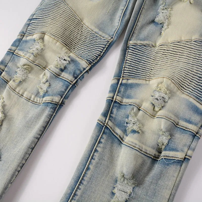 Light blue men's slim fit jeans with hand-frayed distressing on the knees and thighs, featuring a zipper fly and mid-rise waist.