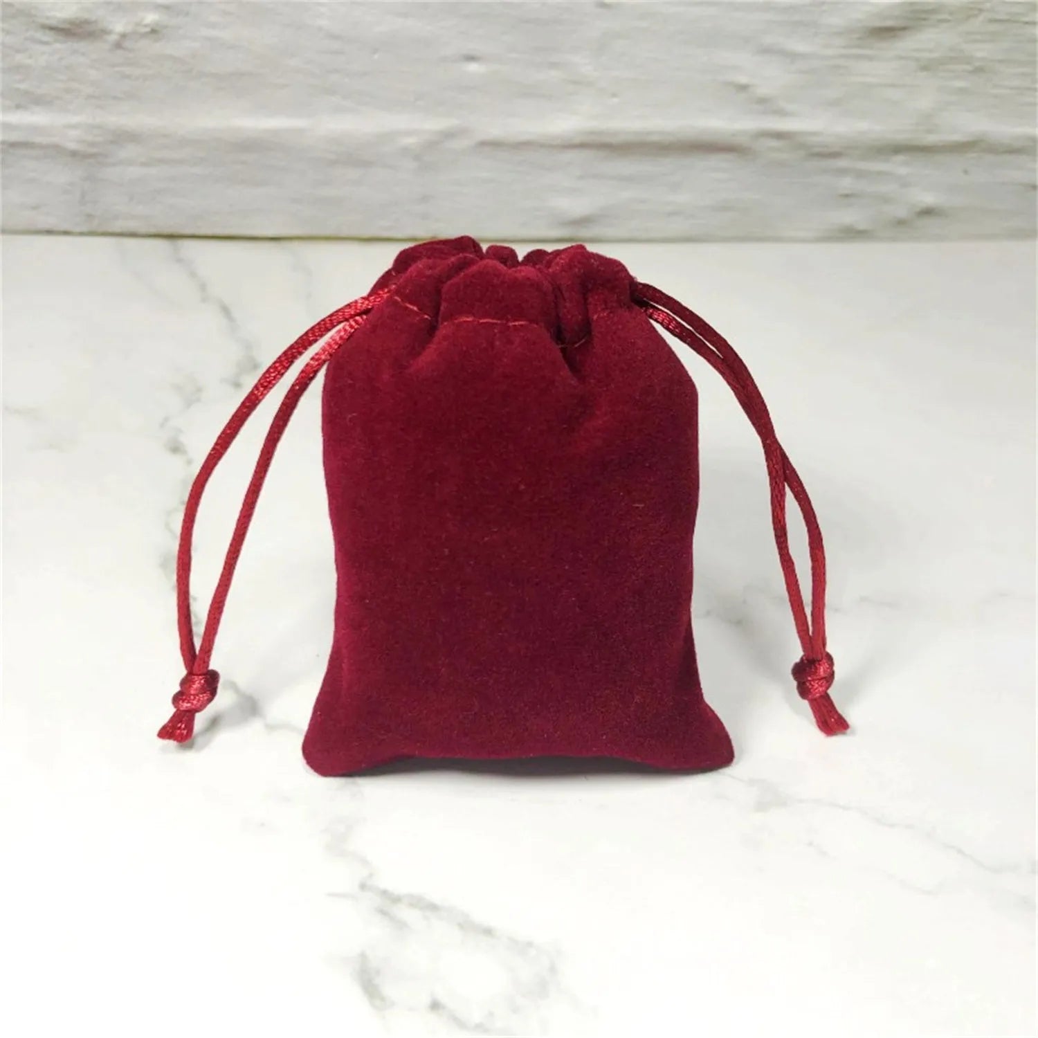 Flannel drawstring bag with beam opening, available in multiple colours and sizes for storage or gifting