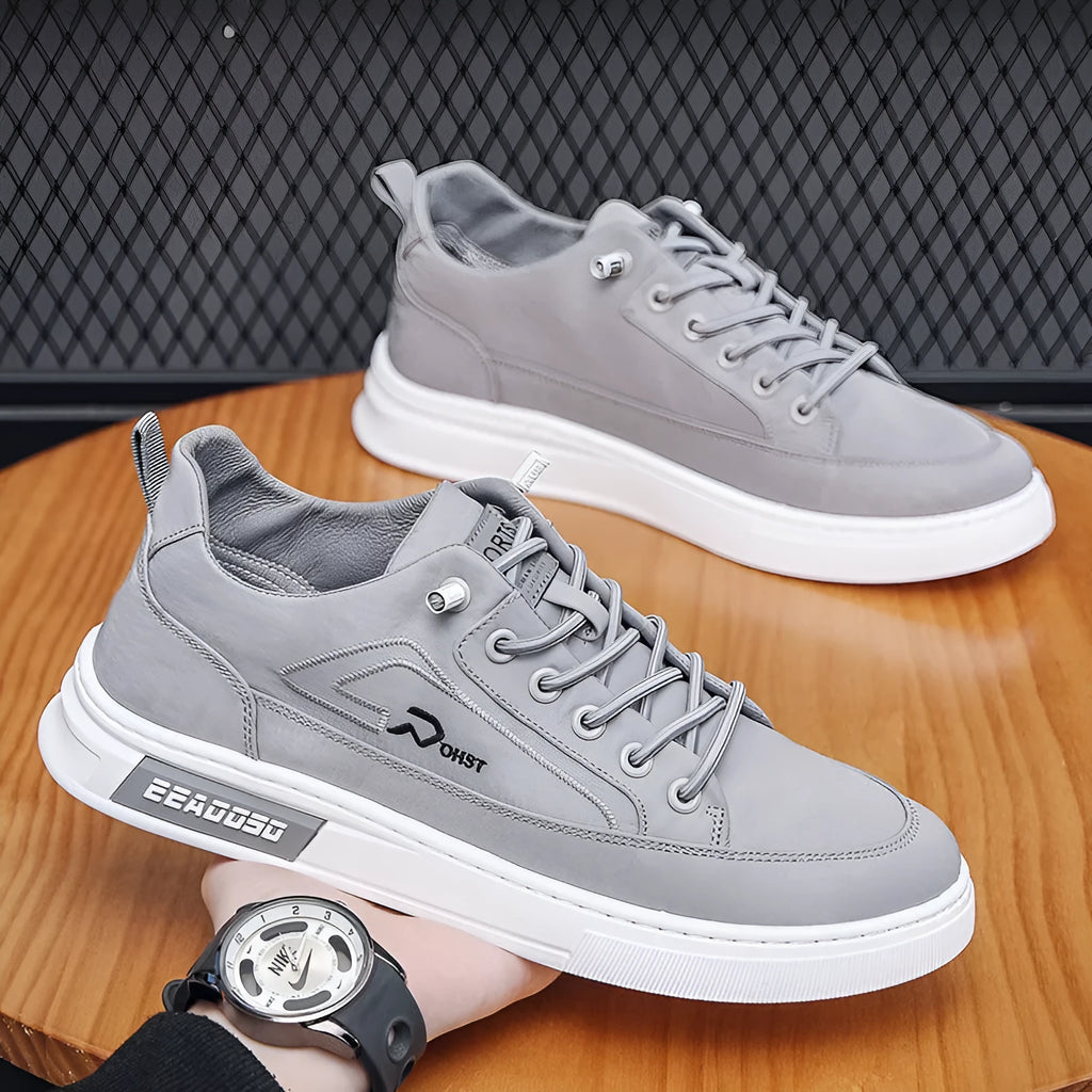 Grey men's low-top canvas casual sneakers with lace-up front and round toe on a rubber sole.