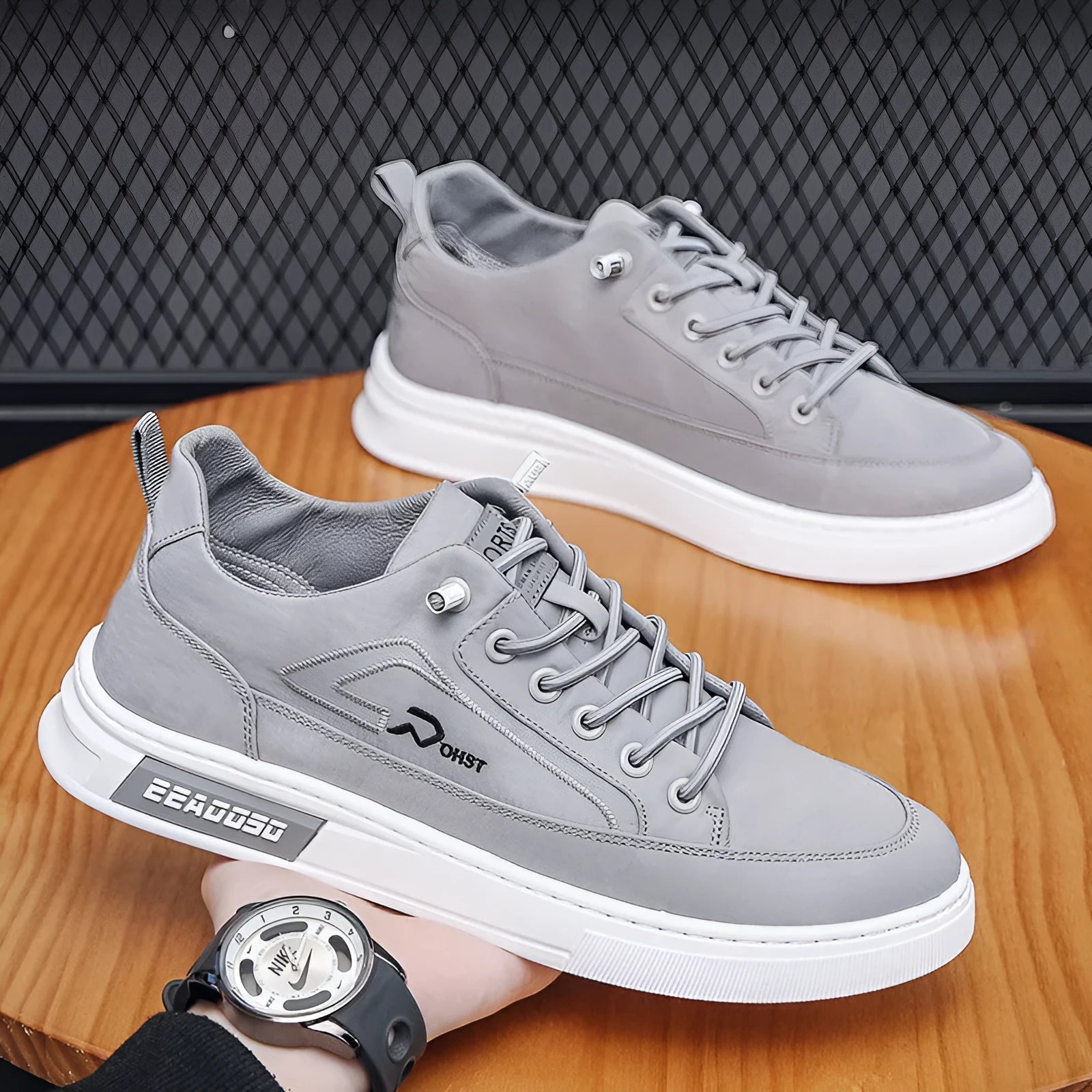 Grey men's low-top canvas casual sneakers with lace-up front and round toe on a rubber sole.