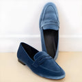 Blue and black plus-size slip-on loafers with a round toe and rubber sole on a white background.