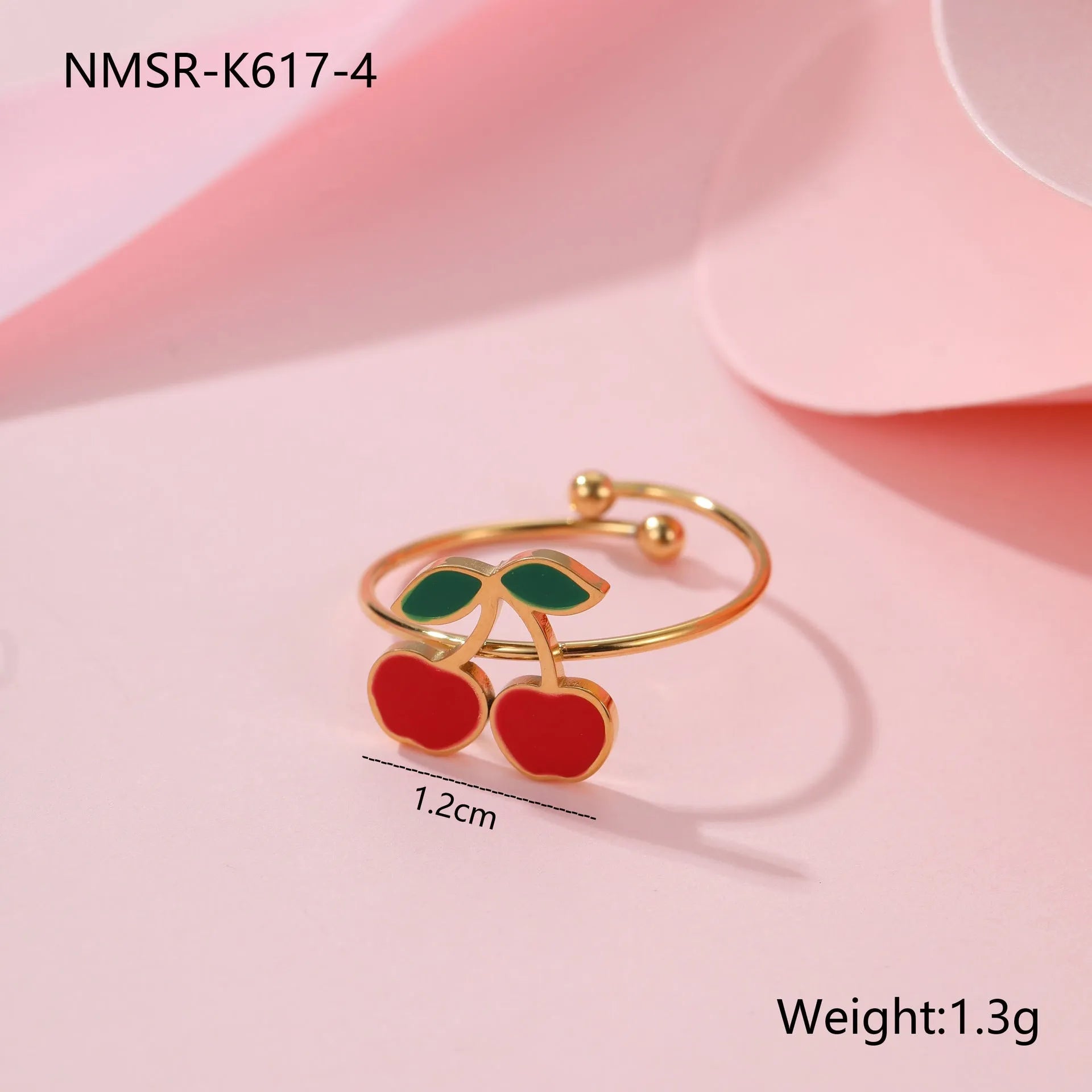 Complete cherry jewellery set showing stainless steel necklace, bracelet, earrings, and ring pieces with electroplated colour finishes