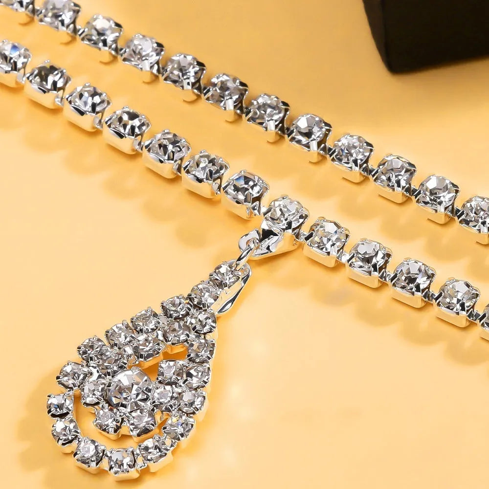 Gold or silver women's waist chain with water drop pendant and rhinestone tassel, showing lobster clasp.