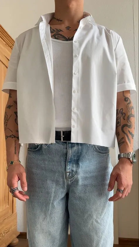 Man wearing a white cropped length short sleeve polyester shirt, casual style.