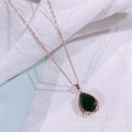 Water drop shaped geometric pendant necklace with rhinestone detailing in rose gold pink colour
