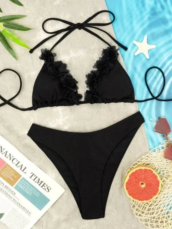 Black gathered style polyester swimwear set with a top and shorts on a mannequin