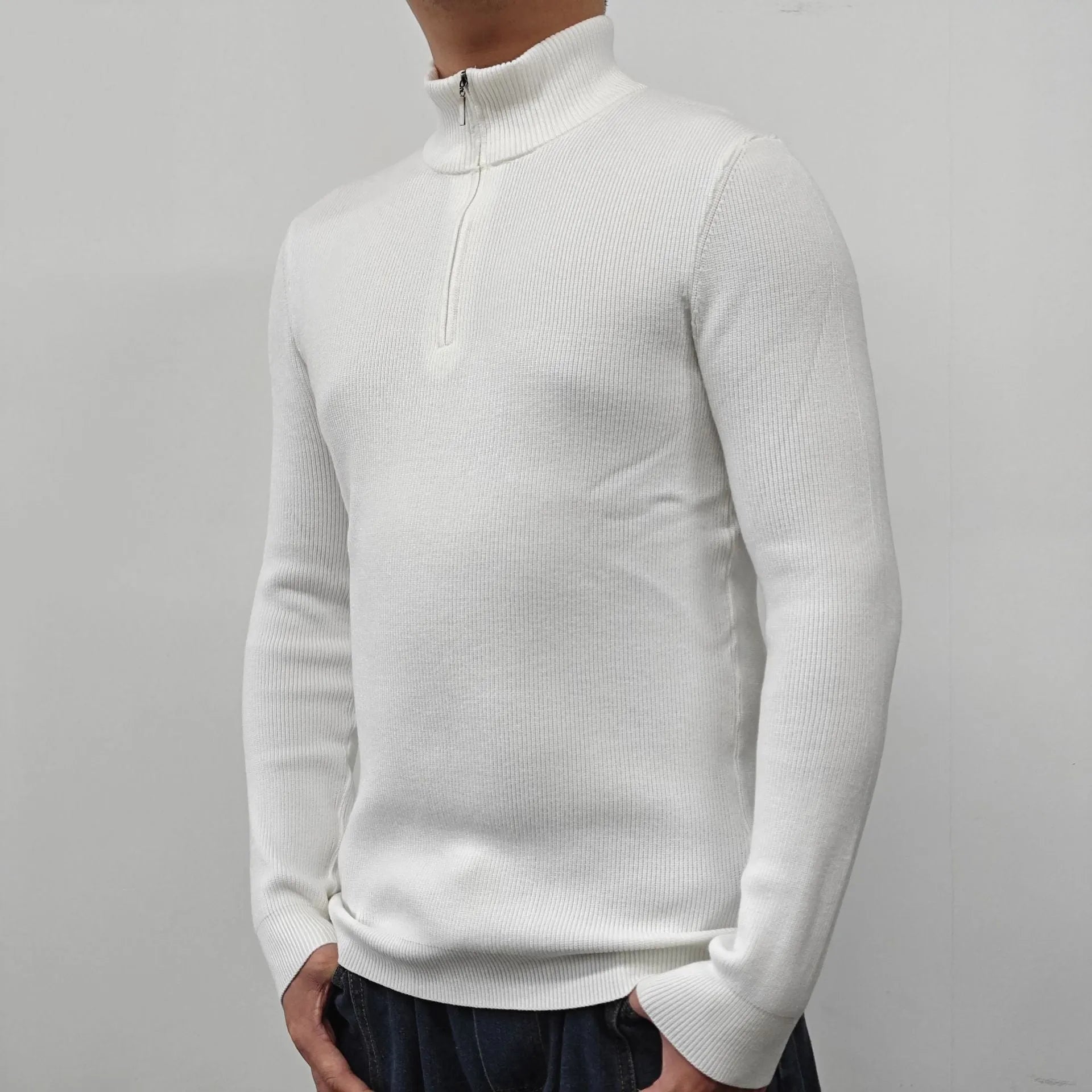A man's grey half-turtleneck zip-up sweater with long sleeves, shown on a hanger.