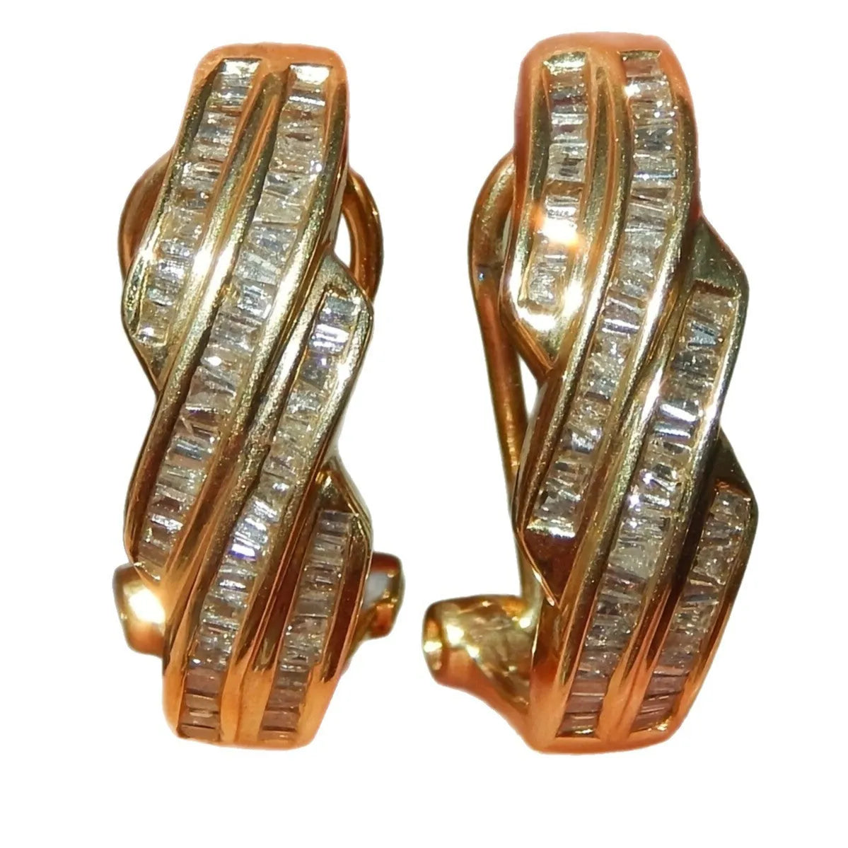 A pair of gold-coloured geometric copper earrings with round design details.