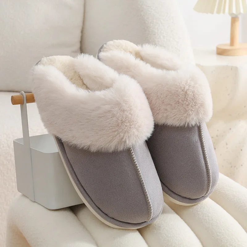 Women's plush winter slippers in grey with a round toe, flat heel, and non-slip PVC sole.