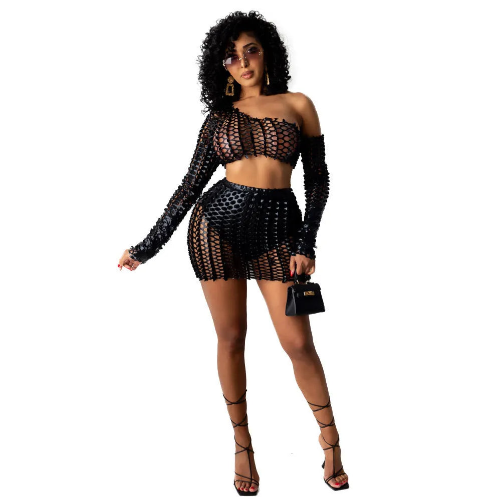 Women's black hollow-out two-piece dress set with sleeveless top and short skirt on a mannequin.
