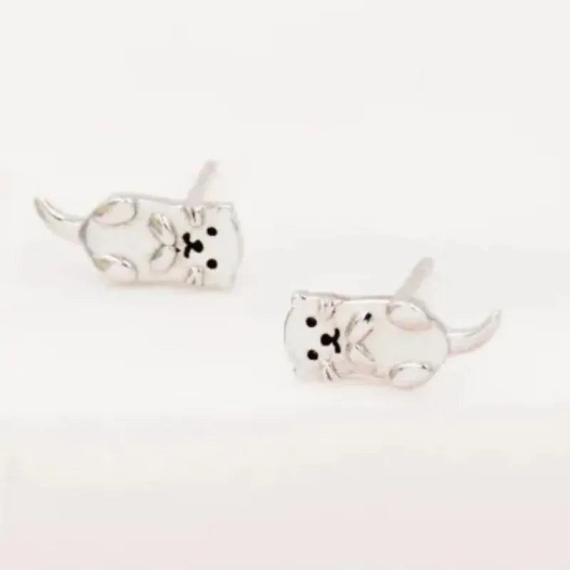Simple compact three-dimensional animal-shaped copper earrings with electroplated finish in white gold colour