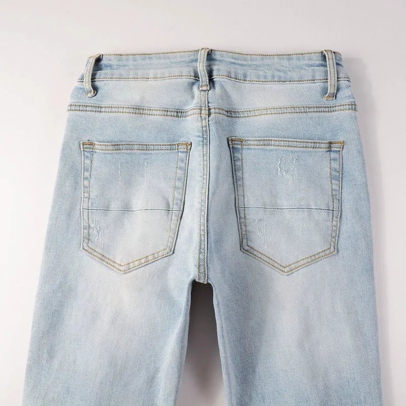 Light blue elastic tight fit jeans for men with patchwork and cat whisker finish