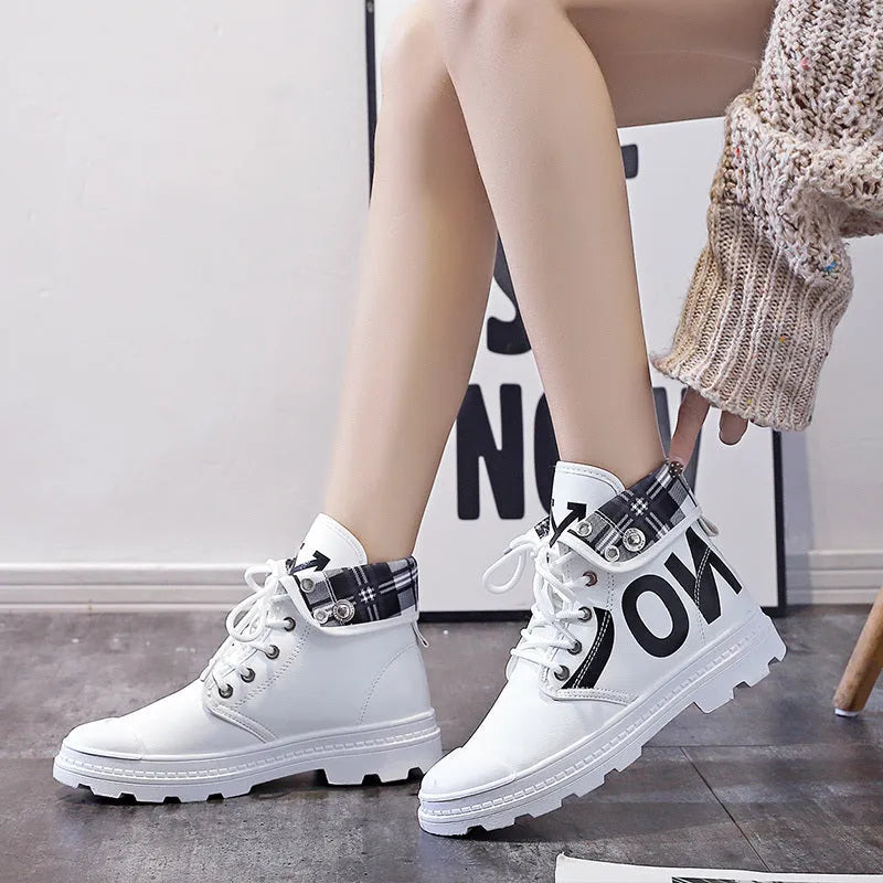 Women's high-top canvas short boots with cross straps and buckles in black, side view