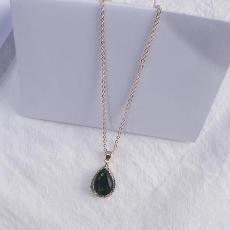 Water drop shaped geometric pendant necklace with rhinestone detailing in rose gold pink colour
