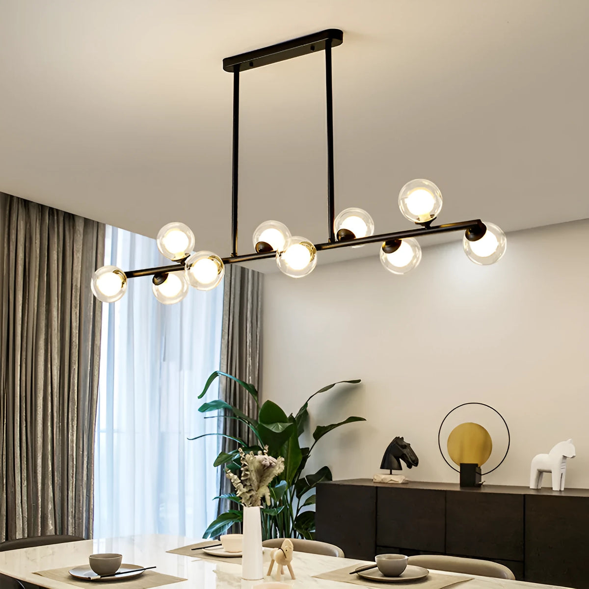 Glass bubble ball chandelier with black iron frame, clear glass shades, and multiple arms